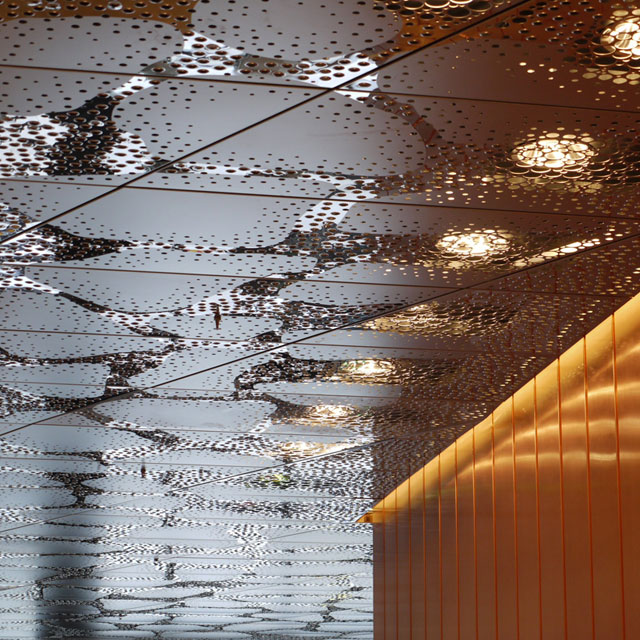 Stockholm, Waterfront Building, Reception Hall, Stainless Steel Ceiling and Copper Wall, Grid Ceiling, Panels Type EXYD-F with Pattern Perforation, Photo EXYD